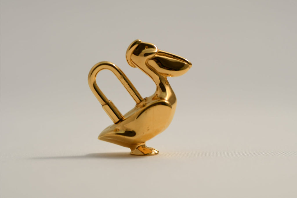 Hermes Cadena Pelican Gold motif bag charm lock 1992
