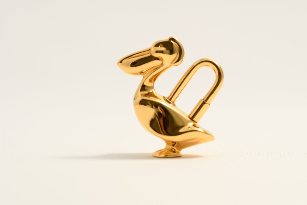 Hermes Cadena Pelican Gold motif bag charm lock 1992