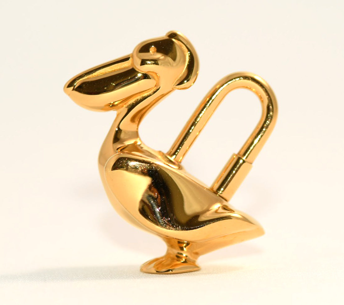 Hermes Cadena Pelican Gold motif bag charm lock 1992